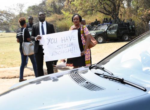 Protesters in Zambia on budget day 2018. They are holding a placard which says: "You have stolen enough!"