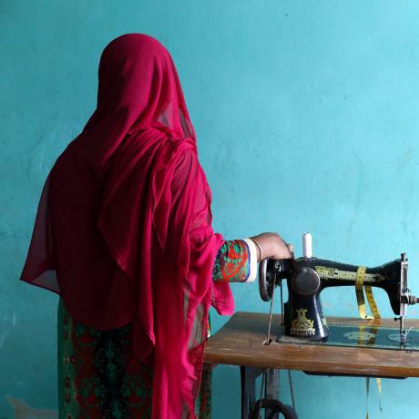 Rahima, with her sewing machine