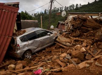 A car and house destroyed by rubble after Cyclone Idai 