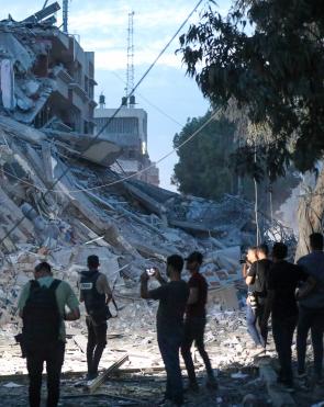 Journalists inspect the damage to Gaza City following bombing by the Israeli army.