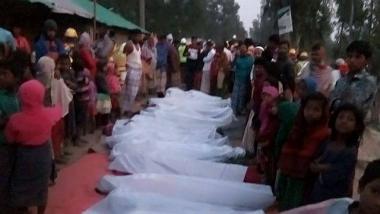 Displaced people road swathed in white burial cloths to demonstrate the depth of their despair