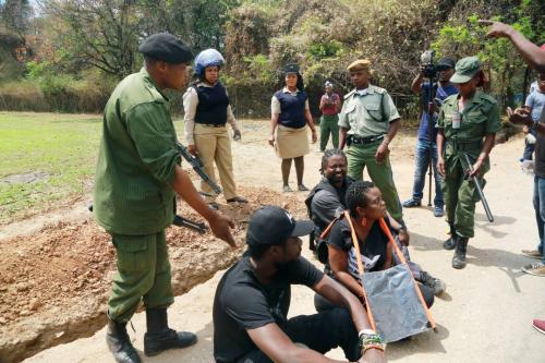 Laura Miti, Pilato and others sit down peacefully after the police intervene