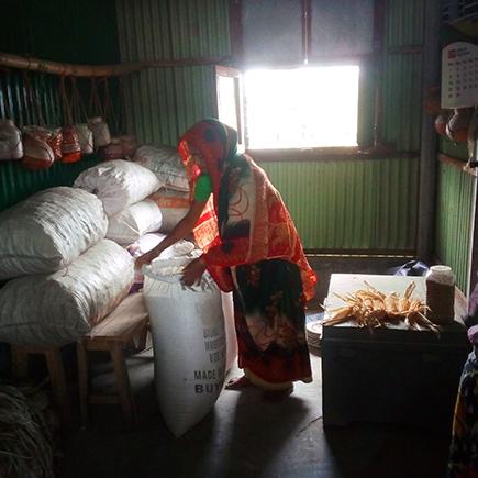 Rejina Begum, leaving her rice grain in the community seed bank