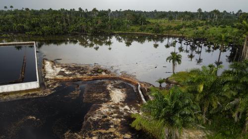 Oil spilled from an abandoned oil well into surrounding water in Okpare.