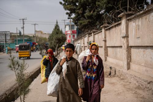 Nematullah, along with his friends, walks the streets of Herat picking litter.