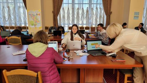 The offices of Moldova for Peace where three women work on laptops