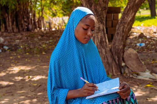 Fauziya, a student from Nigeria, with her school supplies
