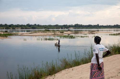 A woman looks across a lake in Zambia's western province. 