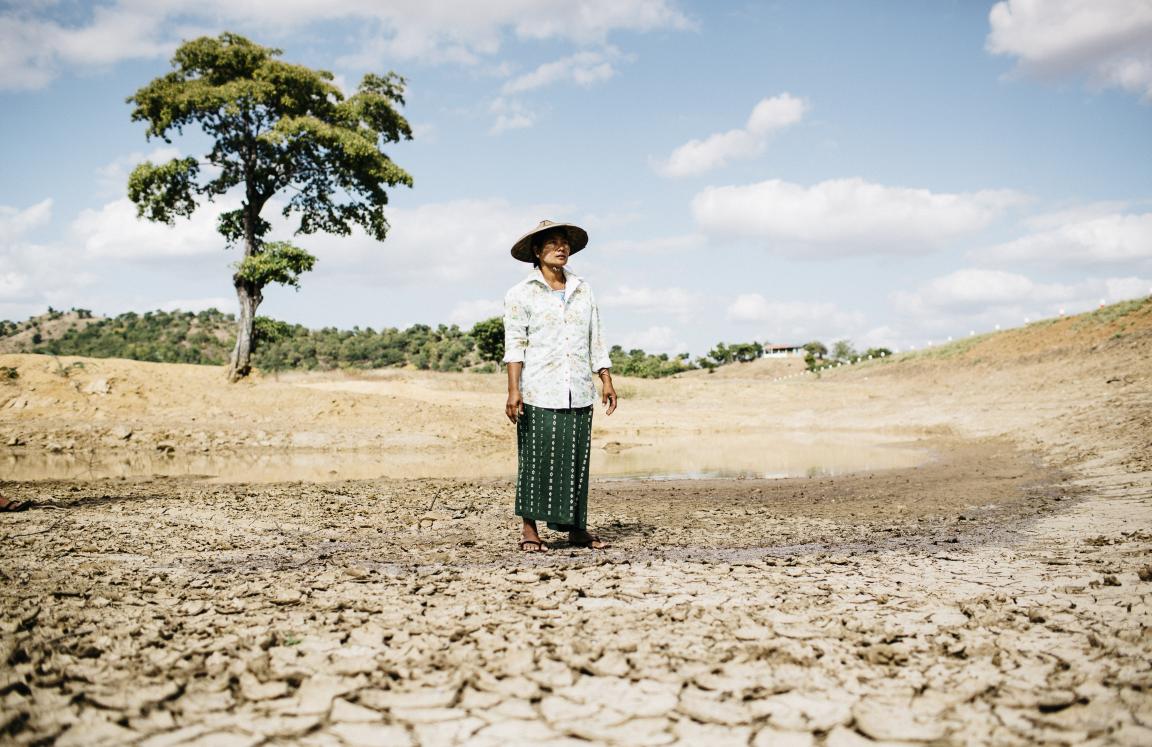 Ma Kyi Myint from Myanmar stands in her drought-afflicted field.
