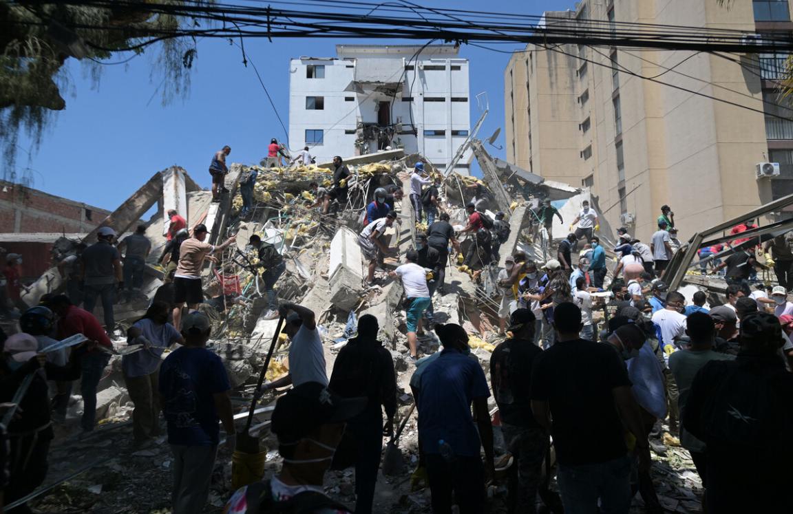 People look for survivors amid the rubble of a collapsed building after an earthquake in Cali, Colombia on August 10, 2026.