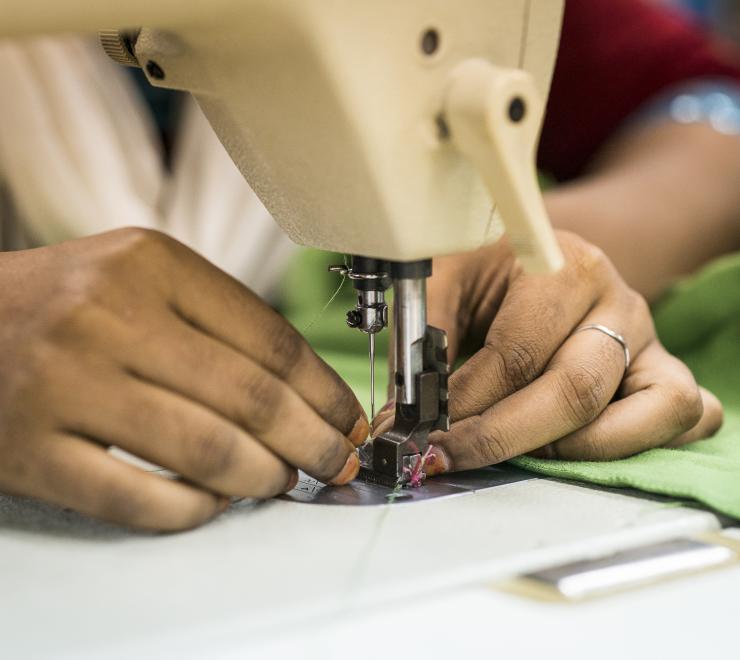 Woman sewing at a garment factory in Bangladesh