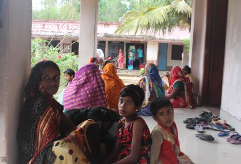 Families crouch outdoors in preparation of Cyclone Fani striking