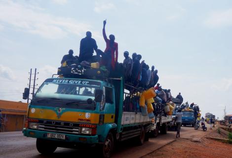 The photo shows members of the Apaa community on an open-top bus