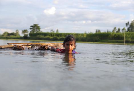 Girl swims through floods