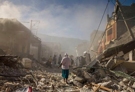 A woman walks through the rubble after the 2010 Haiti earthquake 