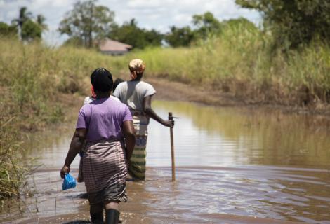 Women working through flooded path