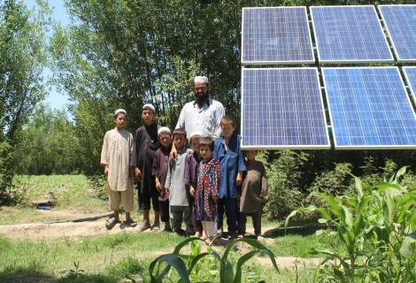 A family standing near a solar energy plant