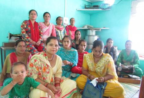 Women taking part in a village women’s right forum in India