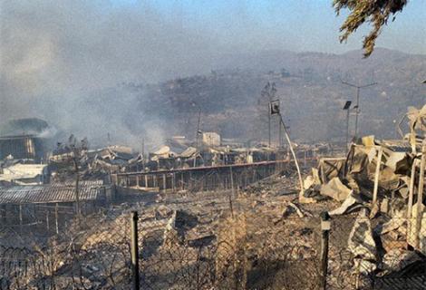 View of the refugee camp Moira in Lesvos, Greece, smokes is coming from the settlement