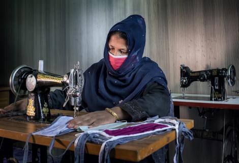 A Rohingya woman makes fasemasks in Cox's Bazar