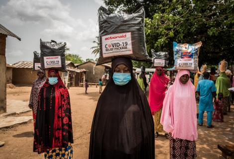 Women wearing face masks receive food support from ActionAid in Nigeria 