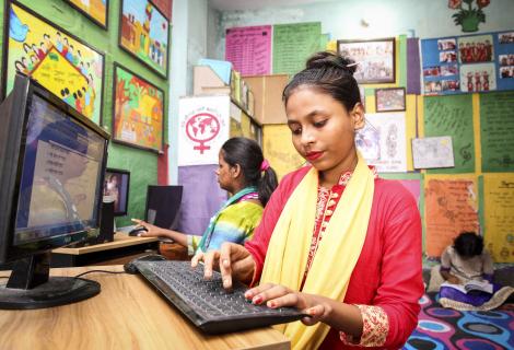 A student practices her computer skills in Dhaka.