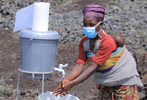 Mwavita uses a handwashing station