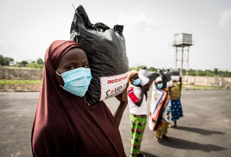 Women from Tungan Nasara community carry their relief packages that they received as part of ActionAid Nigeria's Covid-19 response..