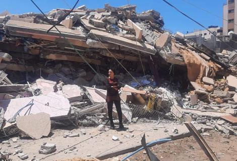 Samah Kassab, senior programme officer at ActionAid Palestine, stands among the devastation caused by Israeli airstrikes in the most recent escalation of violence.
