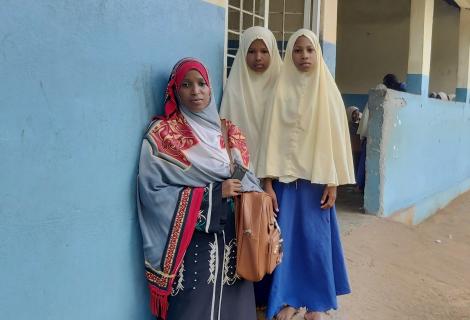 Students stand with their teacher outside a school in North Pemba, Tanzania