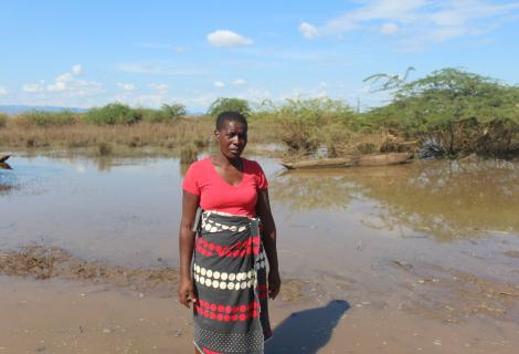 Esnert Thaison, 45, stands in front of her submerged crops after flooding caused by Tropical Storm Ana in Malawi.