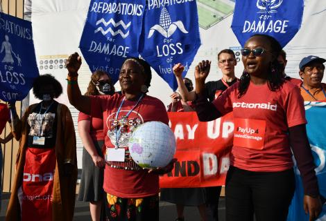 ActionAid staff and activist protest at COP27 campaigning for a loss and damage funding facility.