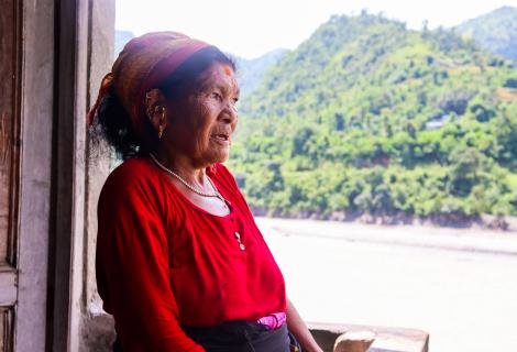 Nanimaya Senchuri looking at what is left after the devastating floods destroyed farmlands in her village