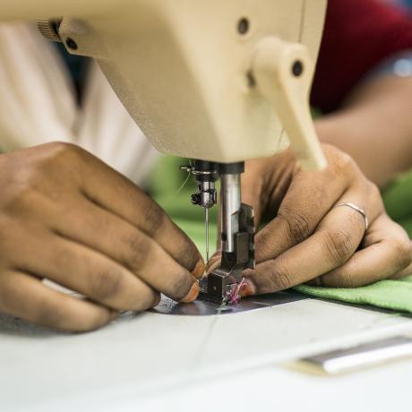 Woman sewing at a garment factory in Bangladesh