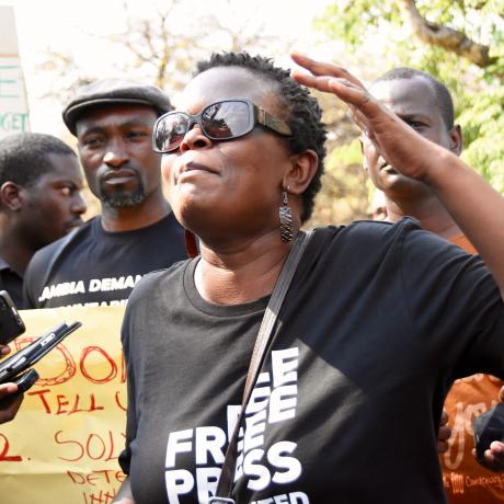 A protester in Zambia calling out corruption