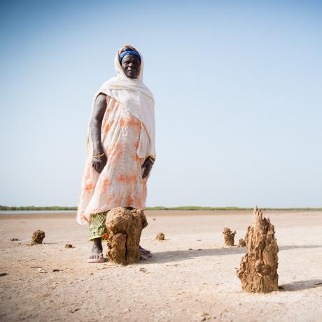 A photo of a woman in a drought area