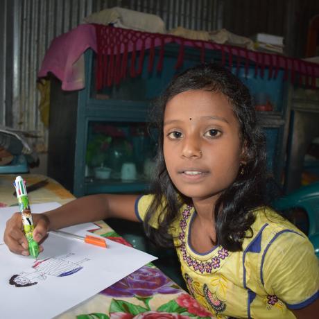 Photo of a nine year old c=girl called Sumaiya doing her homework