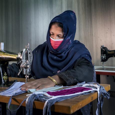 A Rohingya woman makes fasemasks in Cox's Bazar