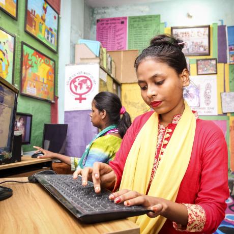 A student practices her computer skills in Dhaka.