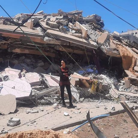 Samah Kassab is a senior programme officer at ActionAid Palestine who lives in north-west Gaza. She is pictured among the devastation caused by Israeli airstrikes.