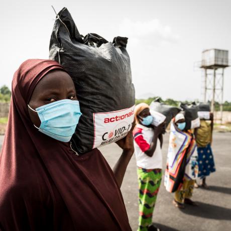 Women from Tungan Nasara community carry their relief packages that they received as part of ActionAid Nigeria's Covid-19 response..