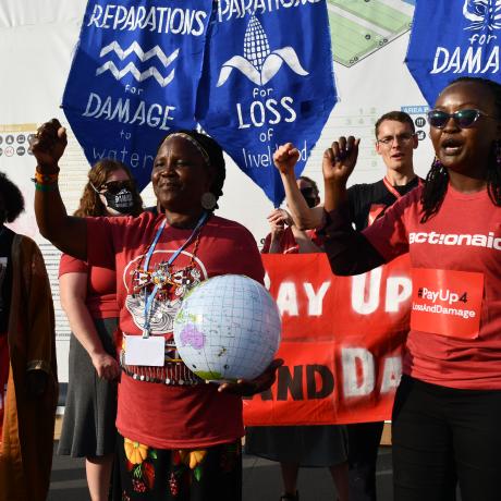 ActionAid staff and activist protest at COP27 campaigning for a loss and damage funding facility.