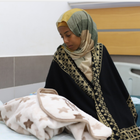 Umm Fulan, a new mother who has just given birth at Al-Awda Hospital.
