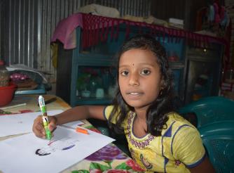 Photo of a nine year old c=girl called Sumaiya doing her homework