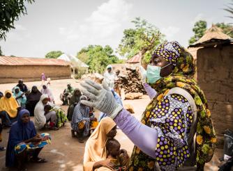 Suwaiba Yakubu Jubrin, Head of Programmes for ActionAid Nigeria informs members of Gwalada community about the novel Corona virus
