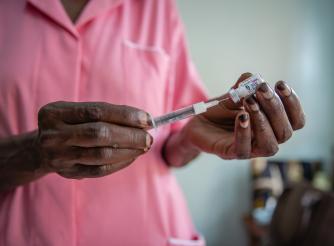 Nurse Margaret Kasolo gives an injection to a client at Kawala Health Center IV in Kampala, Uganda
