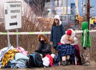 Refugees from Ukraine rest after arriving to the border crossing Vysne Nemecke, Slovakia.
