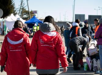 Displaced women and children arrive at Hrebenne, a crossing point on the Polish side of the Ukraine-Poland border where ActionAid and partner PAH are working. 