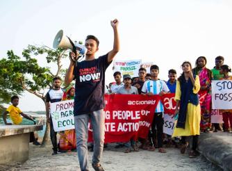 A young climate leader leading a Climate Strike rally at an embankment in Shyamnagar, Bangladesh