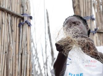 An anonymous woman holds a fishing net in one of Zambia's remote fishing camps.